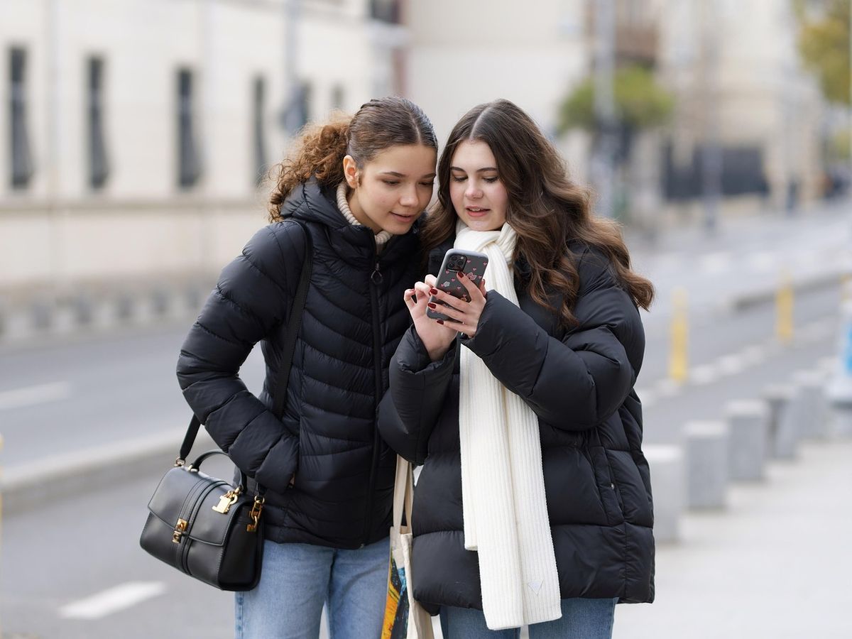 Two friends looking at a phone together