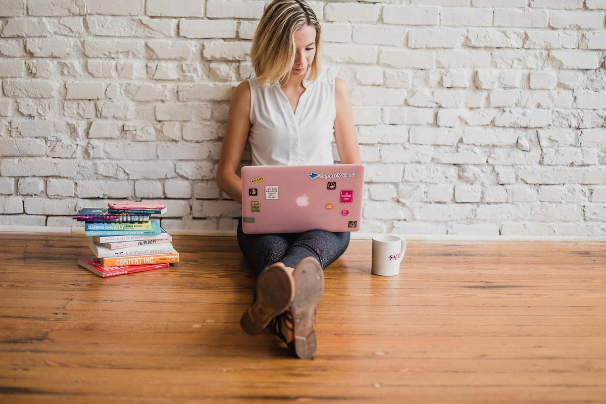 A writer working on a laptop at home